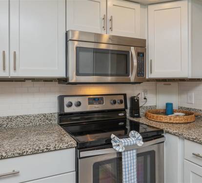 Your modern kitchen features stainless steel appliances and granite countertops, creating the perfect space for preparing delicious meals.
