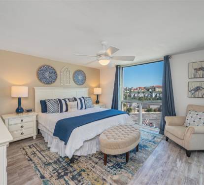 Wake to stunning city views in your serene bedroom sanctuary with coastal-inspired blues and nautical touches creating perfect relaxation.