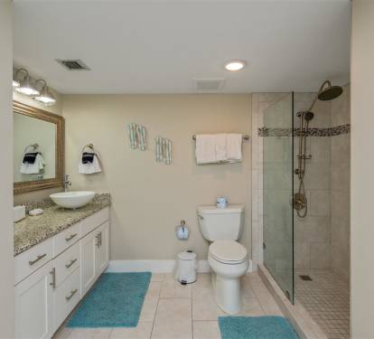 Refresh in your spacious private bathroom with granite vanity, walk-in shower, and soft turquoise accents that add coastal charm.