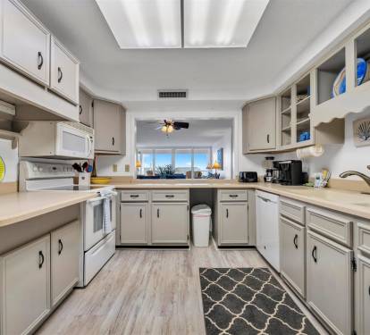 Your fully equipped kitchen features modern appliances and ample counter space, perfect for preparing meals while enjoying the coastal view.