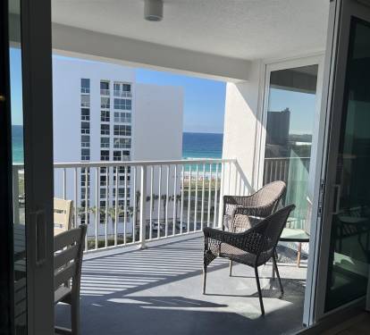 Step onto your private balcony and sink into comfortable wicker chairs while soaking up stunning ocean views and coastal breezes.