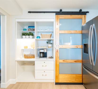 Your stylish pantry features a charming barn door and organized shelving, perfect for storing snacks and cooking essentials during your stay.