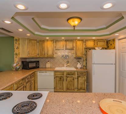 Your fully equipped kitchen features warm wood cabinets, granite countertops, and everything you need to create memorable meals during your stay.