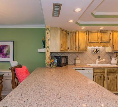 Your fully-equipped kitchen features granite counters, warm wood cabinets, and everything needed to create memorable meals during your stay.