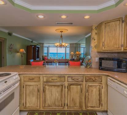Your fully equipped kitchen opens to the living area, creating a seamless flow for cooking while enjoying ocean views and gathering spaces.