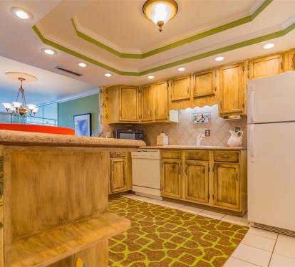 Your fully-equipped kitchen features warm wood cabinets, granite counters, and all appliances needed for memorable meals during your stay.