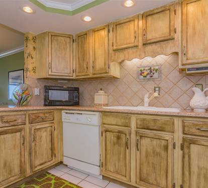 Your fully equipped kitchen features rustic wood cabinets and charming tile backsplash, perfect for preparing meals during your stay.