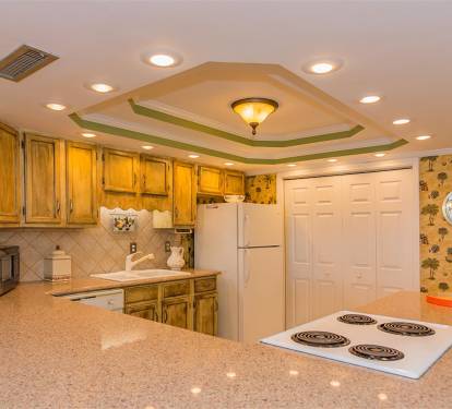 Your spacious kitchen features warm wood cabinets, granite counters, and everything needed to prepare meals during your stay.