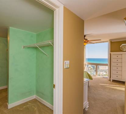 Your spacious closet with hanging rod sits steps from your bedroom, where stunning ocean views await through large windows.