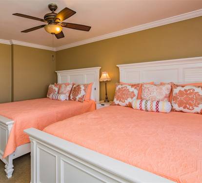 Rest comfortably in your twin bed sanctuary with cheerful coral linens and thoughtful touches like bedside lighting.