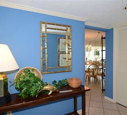 Your bright entryway welcomes you with coastal blue walls and elegant decor, setting a relaxing tone for your stay.