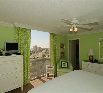 Relax in your bright bedroom with fresh green walls and a spectacular city view from your window.