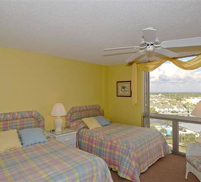 Drift off to sleep in your bright bedroom with twin beds, ceiling fan, and expansive views over the surrounding area.