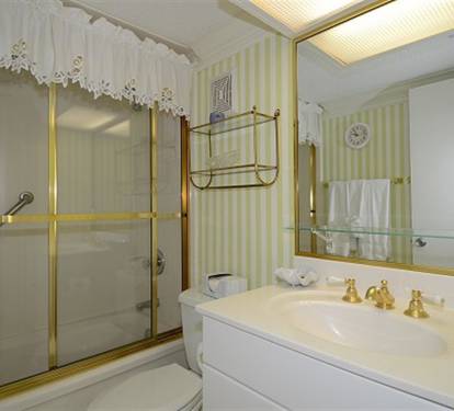Your elegant bathroom features gold fixtures, marble counters, and classic charm for a luxurious refreshing experience.