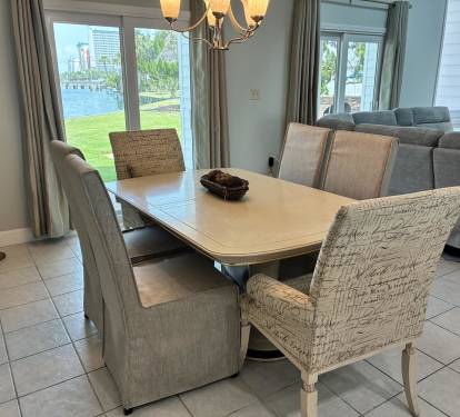 Gather around this elegant dining table where waterfront views create the perfect backdrop for your memorable meals together.