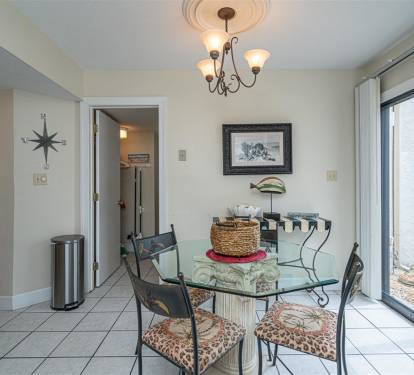 Your dining space features a glass-top table and elegant chandelier, creating the perfect spot for memorable meals together.