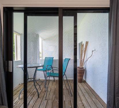 Step out to your private balcony and enjoy morning coffee at your intimate bistro table surrounded by calming blue.