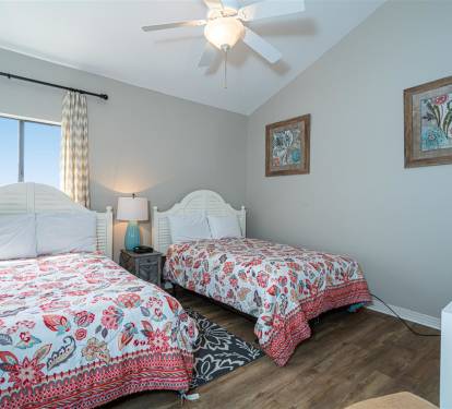Drift off to sleep in twin beds with cheerful paisley linens, while your ceiling fan keeps you cool and comfortable all night long.