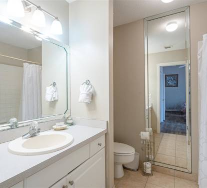 Step into your private bathroom sanctuary with bright vanity lighting, fresh towels, and everything you need for a refreshing start to your day.