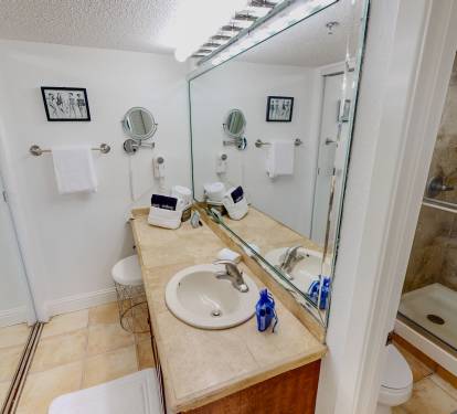Refresh in your private bathroom with marble counters, walk-in shower, and thoughtful amenities ready for your comfort.