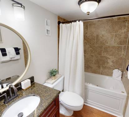 Step into your spa-like bathroom with elegant granite counters, beautiful tile work, and plush towels waiting for your arrival.