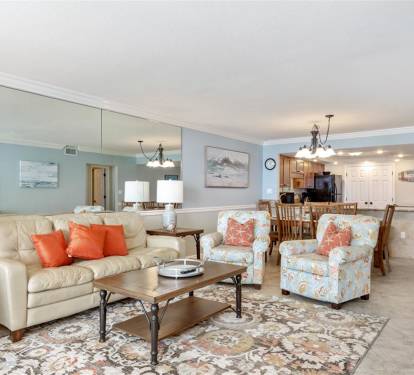 Relax in your spacious open-concept living area featuring plush seating and a fully equipped kitchen for memorable vacation moments.