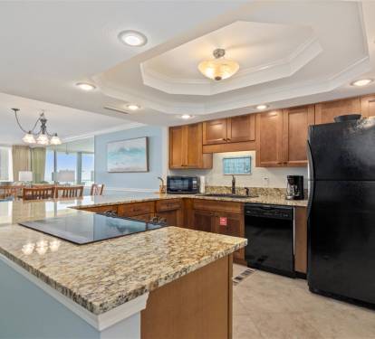 Your fully equipped kitchen features granite countertops and modern appliances, perfect for preparing meals while enjoying ocean views.