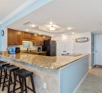 Your fully equipped kitchen features granite counters, breakfast bar seating, and everything needed to create memorable meals during your stay.