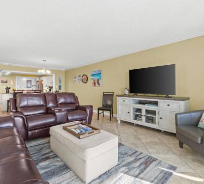 Sink into rich leather seating while you watch your favorite shows on the large flat-screen TV in this spacious, sunlit living area.