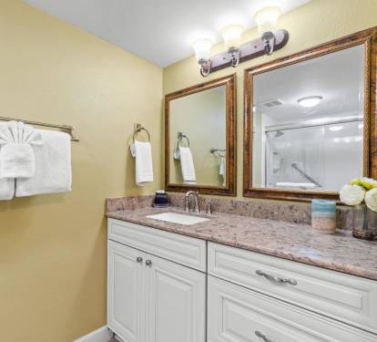 Your spacious bathroom features elegant granite countertops, warm lighting, and thoughtful touches like fresh flowers to make your stay feel special.
