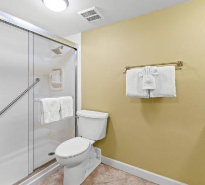 Your private bathroom features a spacious walk-in shower, fresh towels, and thoughtful accessibility features for your comfort.