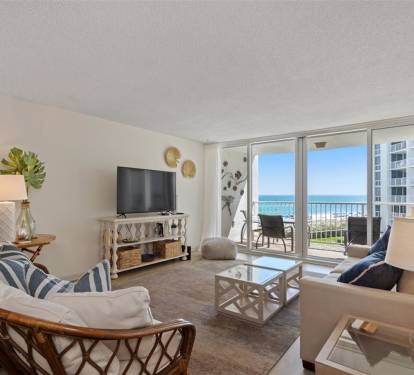 Relax in your coastal living room with stunning ocean views from the private balcony. Comfortable seating and beach-inspired decor create your perfect seaside retreat.