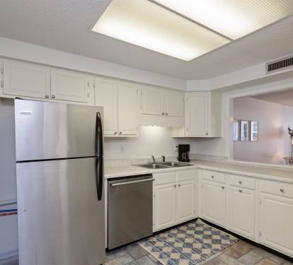 Your fully equipped kitchen features stainless steel appliances and bright white cabinetry, perfect for preparing meals during your stay.