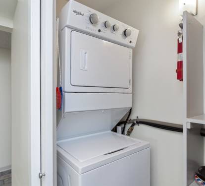 Your in-unit washer and dryer combo keeps your clothes fresh throughout your stay, conveniently tucked away in this clean, organized space.