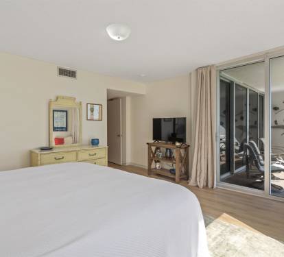 Wake up to ocean breezes in your coastal bedroom, where sliding doors open to your private balcony and comfort meets seaside charm.
