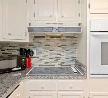 Your modern kitchen features granite counters, glass tile backsplash, and full appliances for easy meal prep.