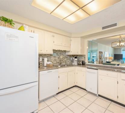 Your modern kitchen awaits with granite counters and white cabinetry, perfect for preparing meals while enjoying the open-concept flow.