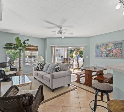 Sink into the plush sofa and enjoy your tropical oasis with calming décor, modern amenities, and peaceful balcony views.