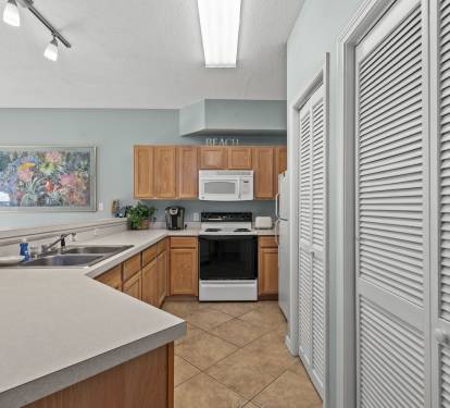 Your fully equipped kitchen features modern appliances and ample counter space for preparing delicious meals during your beach getaway.