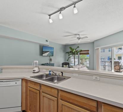 Your open kitchen flows seamlessly into the living area, with views of the pool deck creating the perfect space for vacation cooking.