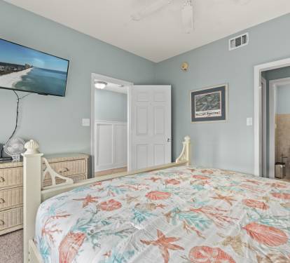 Drift off to sleep in your coastal-themed bedroom, complete with ocean-view TV and private bathroom access.