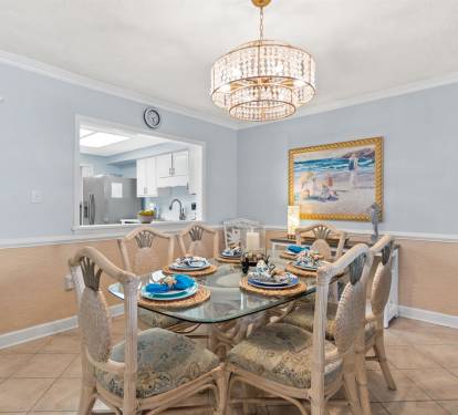 Gather around this elegant dining table where crystal chandeliers cast warm light over your memorable meals together.