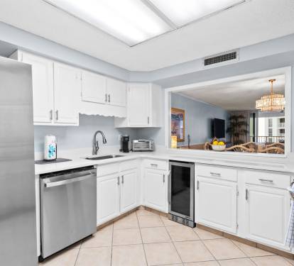 Your fully-equipped kitchen features stainless steel appliances and gleaming white cabinets, perfect for preparing meals during your stay.