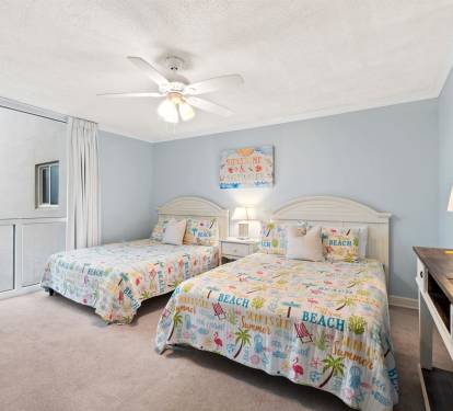 Your beach-themed bedroom features twin beds with tropical decor, perfect for siblings or friends. Enjoy the coastal charm and comfort.