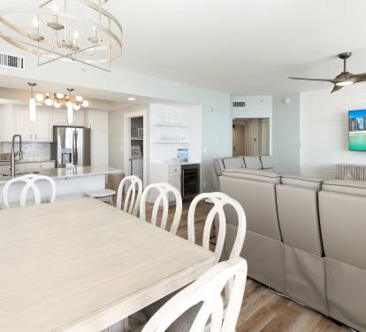 Gather around your spacious dining table while enjoying ocean views on the large screen TV in this bright, open-concept space.
