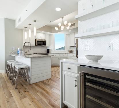 Your gourmet kitchen awaits with marble counters, stainless appliances, and coastal views perfect for memorable meals.