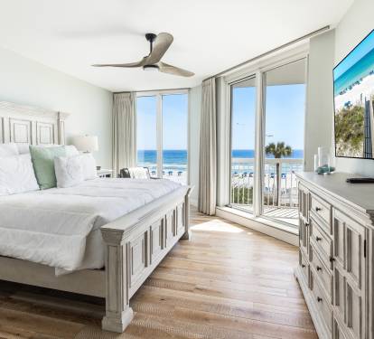 Wake up to breathtaking ocean views from your serene bedroom, where morning light dances across pristine white linens.