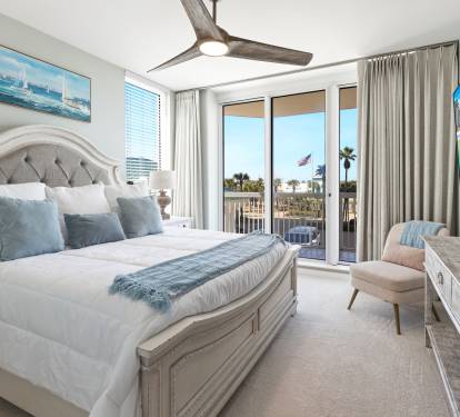 Wake up to ocean breezes in your elegant bedroom featuring a plush king bed and private balcony access with tropical views.
