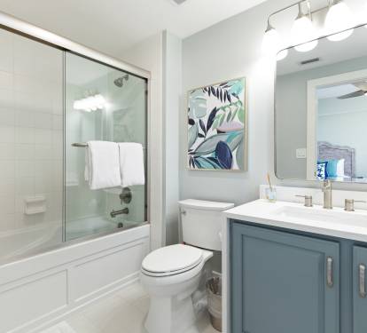 Refresh in your stylish bathroom featuring a spacious tub-shower combo, modern vanity, and bright coastal-inspired decor.