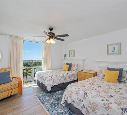 Wake up to stunning ocean views in your comfortable twin bedroom with coastal décor and refreshing ceiling fan.
